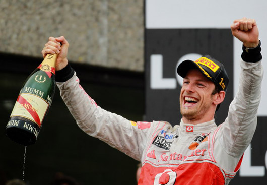 MONTREAL, CANADA - JUNE 12: Jenson Button of Great Britain and McLaren celebrates on the podium after winning the Canadian Formula One Grand Prix at the Circuit Gilles Villeneuve on June 12, 2011 in Montreal, Canada. (Photo by Paul Gilham/Getty Images)
